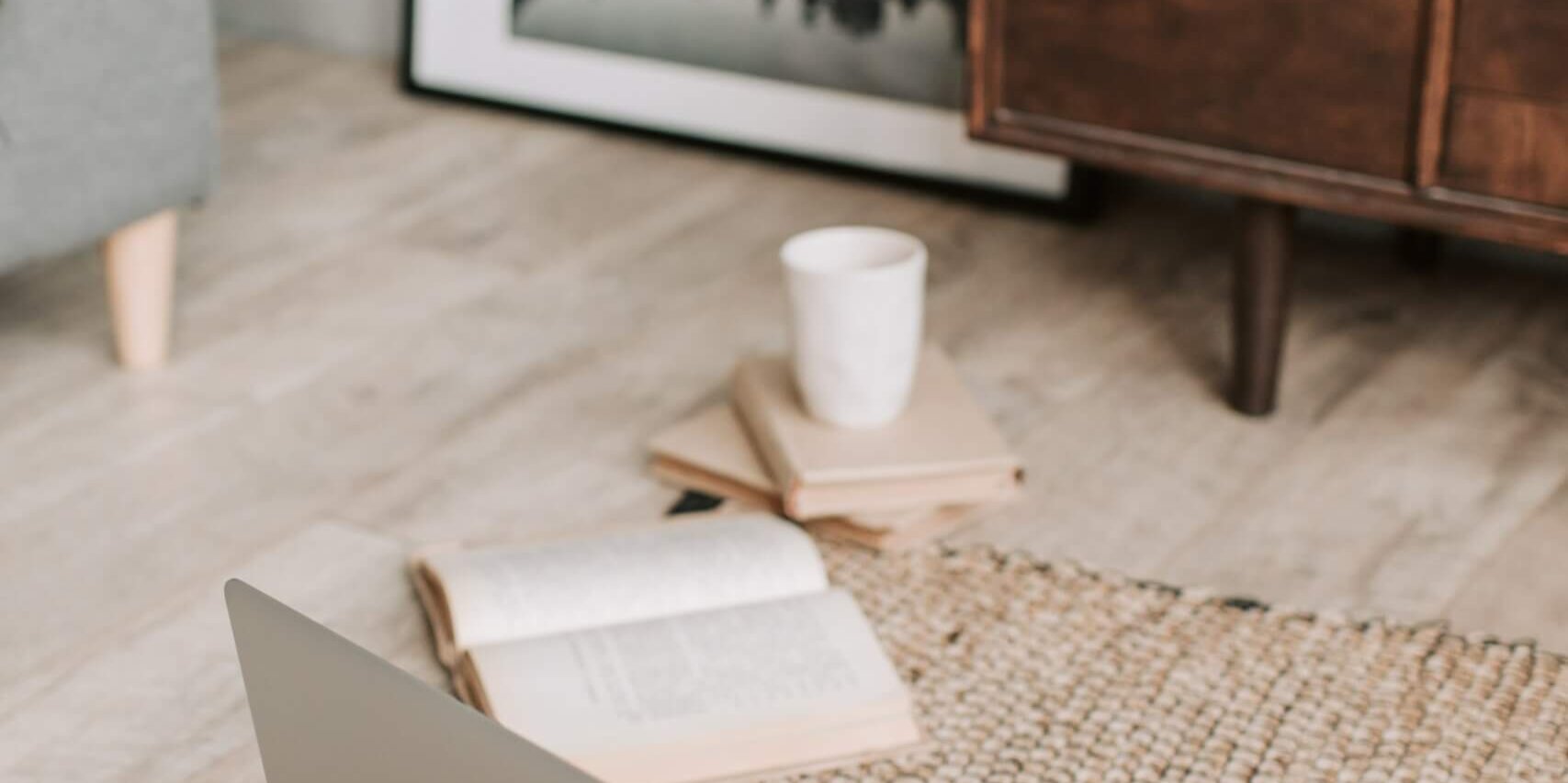 Laptop on the floor with bible and coffee