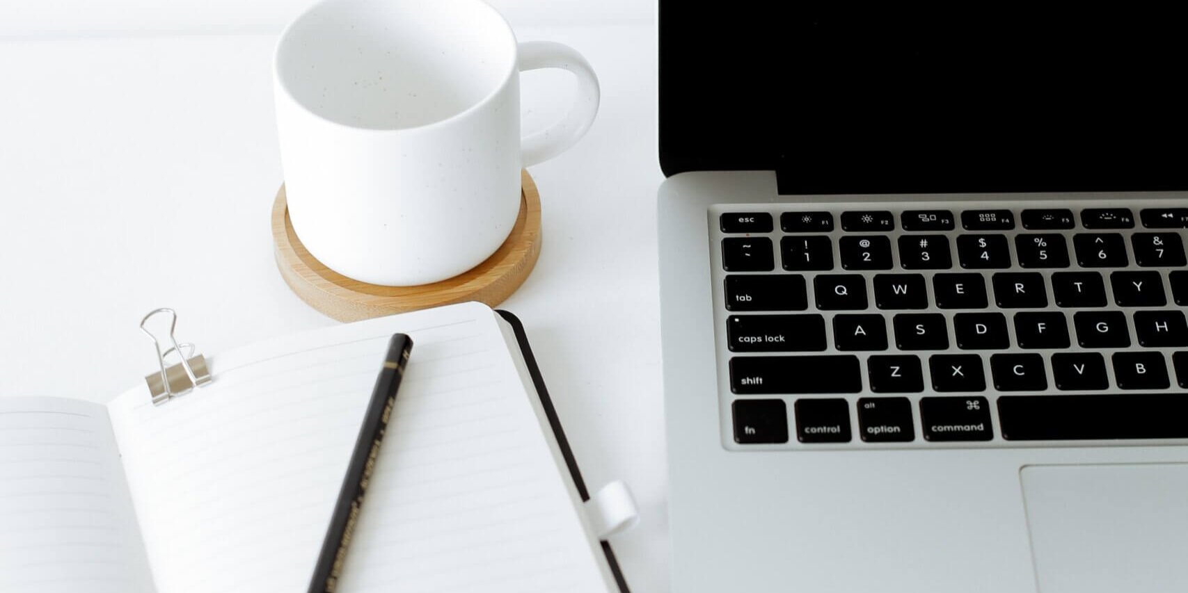 A Laptop a Notebook and a coffee